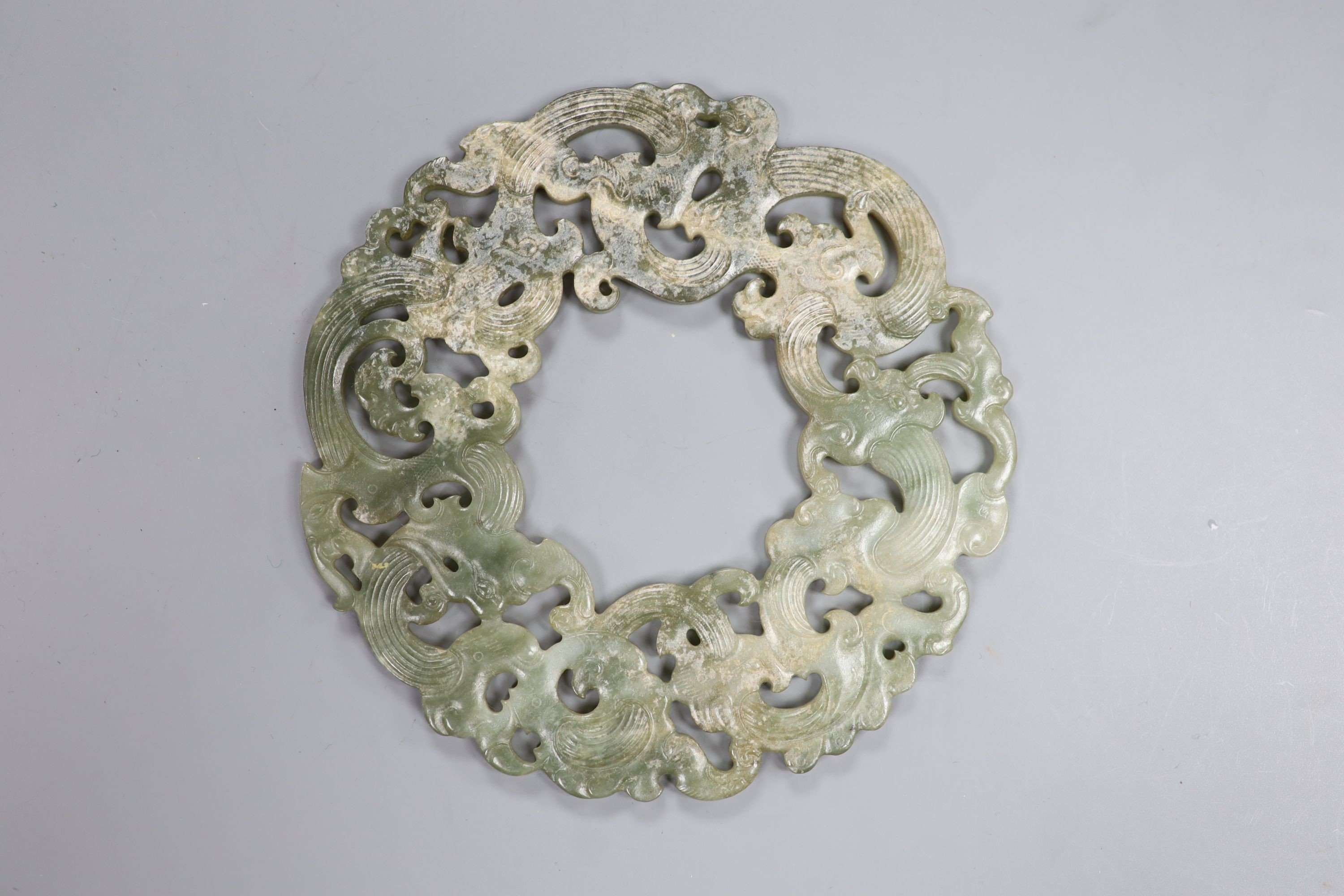 A Chinese archaistic celadon jade disc, D. 23.2cm